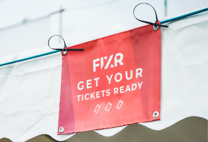 Sign at event which reads 'FIXR - Get Your Tickets Ready'